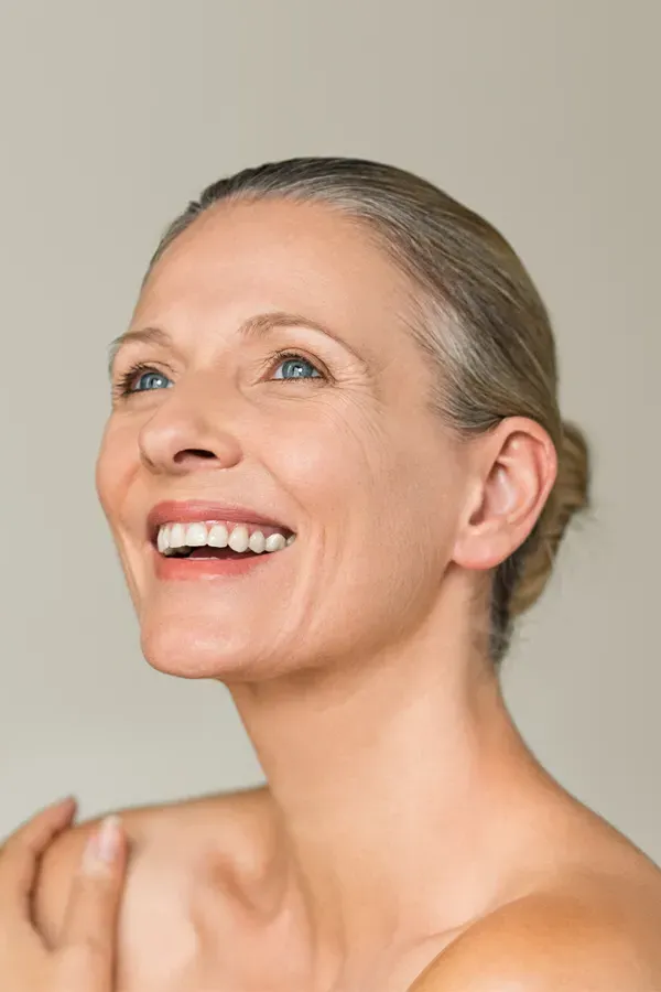 A middle-aged woman with smooth, beautiful skin. Get Biotin IV therapy from Christine Collins, MD in Westside/Beverly Hills.