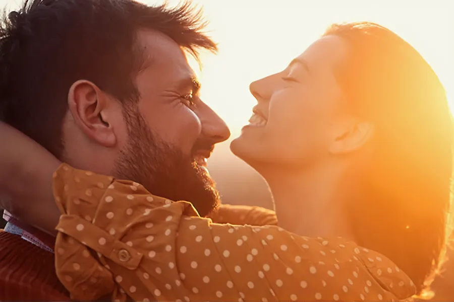 A couple embrace in the sunset. Schedule Hangover IV therapy from Christine Collins, MD in Westside/Beverly Hills.