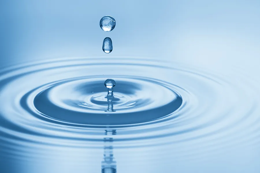 Drops of water rippling in a smooth pool. Get Hydration IV Therapy from Christine Collins, MD in Westside/Beverly Hills.
