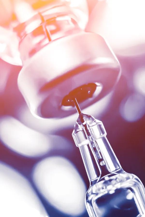 A syringe drawing fluid from a vial. Get Vitamin B-Complex Injections from Christine Collins, MD in Westside/Beverly Hills.