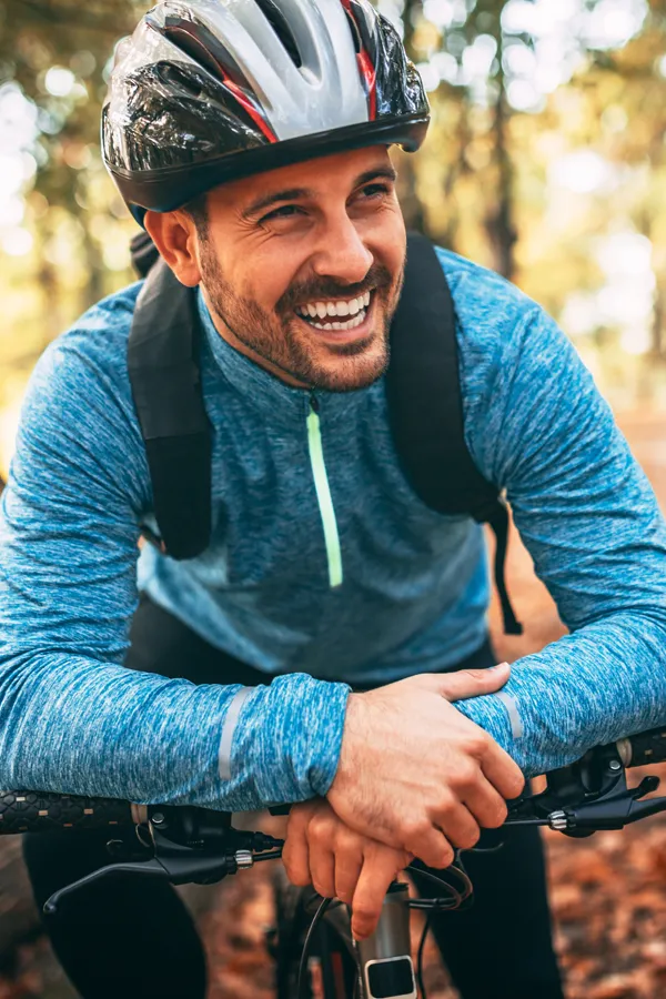 A smiling man getting ready for a cycling trip. Get treatment for adrenal hormone disorder from Frank Lanzisera, D.C. in Tampa Bay Metro.