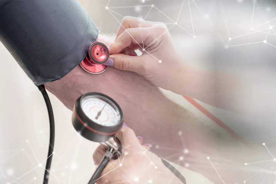A man gets his blood pressure taken. Schedule hypertension treatment from Frank Lanzisera, D.C. in Tampa Bay Metro.
