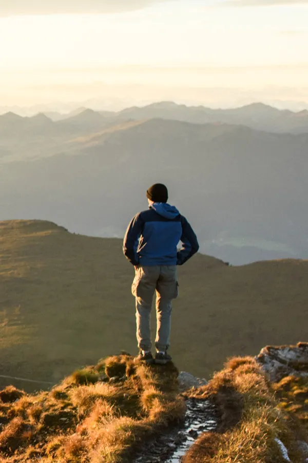A man on a mountaintop looks out onto the horizon. Get low sperm count treatment from Frank Lanzisera, D.C. in Tampa Bay Metro.