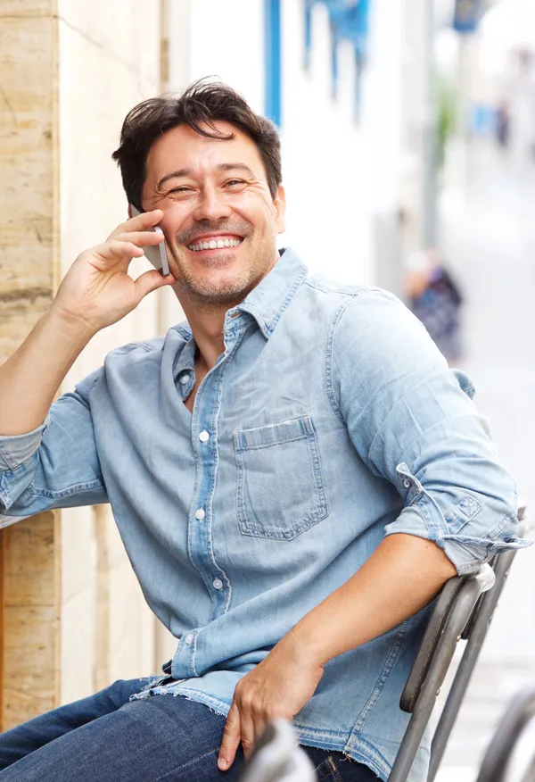 A man rubs his neck in pain. Get Regenerative Medicine for Neck Pain from Frank Lanzisera, D.C. in Tampa Bay Metro.