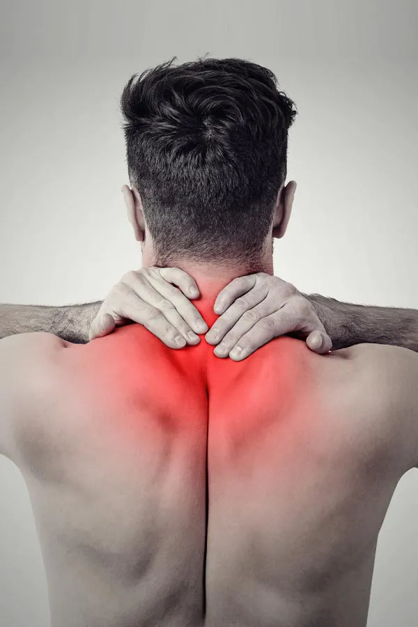 A man holds his upper back in pain. Get Regenerative Medicine for Back Pain from Frank Lanzisera, D.C. in Tampa Bay Metro.