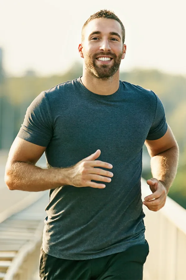 A man happily running for exercise. Get regenerative medicine for joint pain from Frank Lanzisera, D.C. in Tampa Bay Metro.