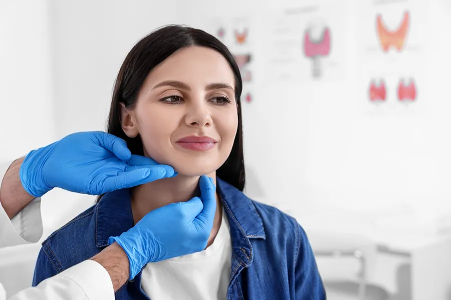 A woman gets a thryoid examination. Get thyroid optimization treatment from Frank Lanzisera, D.C. in Tampa Bay Metro.